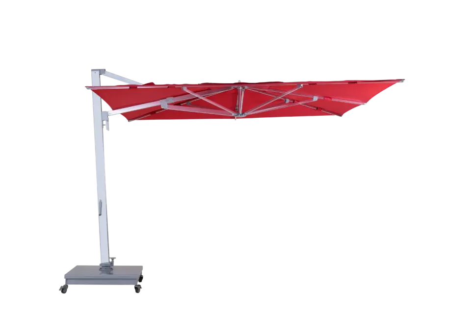 A fully open, red Aman cantilever umbrella shown from the side, highlighting its expansive square canopy and robust side-post aluminum frame on a wheeled base.