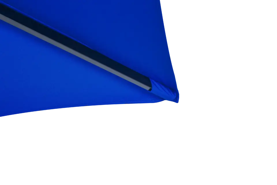 A macro shot of the reinforced corner pocket of the royal blue Luciano umbrella canopy, showing where the support rib connects securely to the fabric for enhanced longevity.