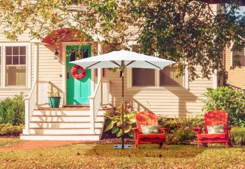 Tempo Amazon Umbrella in an outdoor setting in front of a house.