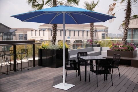 Tempo Callas Umbrella in an outdoor setting with patio furniture.