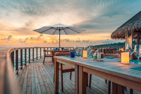 Tempo Geroge umbrella at outdoor restaurant setting with sunset view