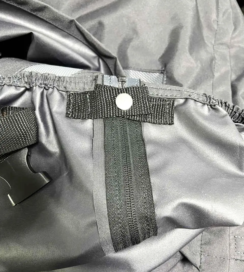 YKK zipper and trim detail — controlled at all wear points.