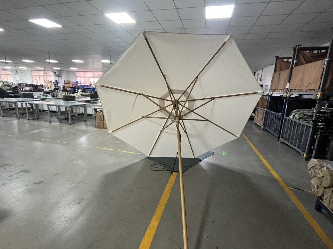 Underside view showing wood-grain transfer frame structure on a commercial umbrella