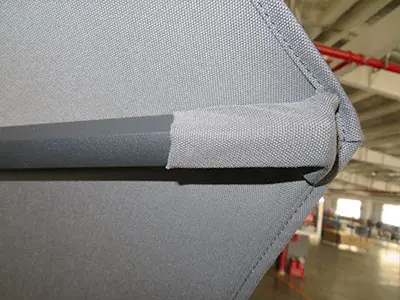 Reinforced rib-fabric connection for enhanced wind resistance