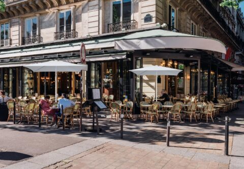 Tempo Poster umbrella in use at an outdoor cafe