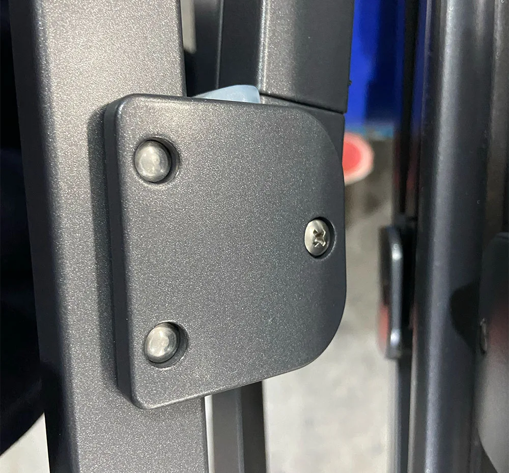 Hardware detail on the grey frame showing Tiger 049 powder coating finish and custom M12 fastener integration.