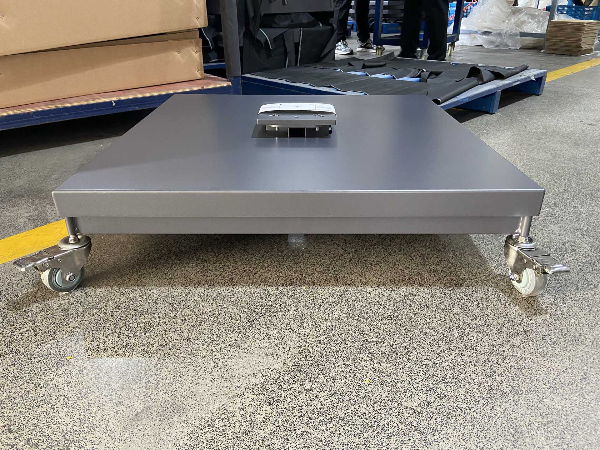 Grey Tiger powder-coated cross-shaped commercial umbrella base with locking casters